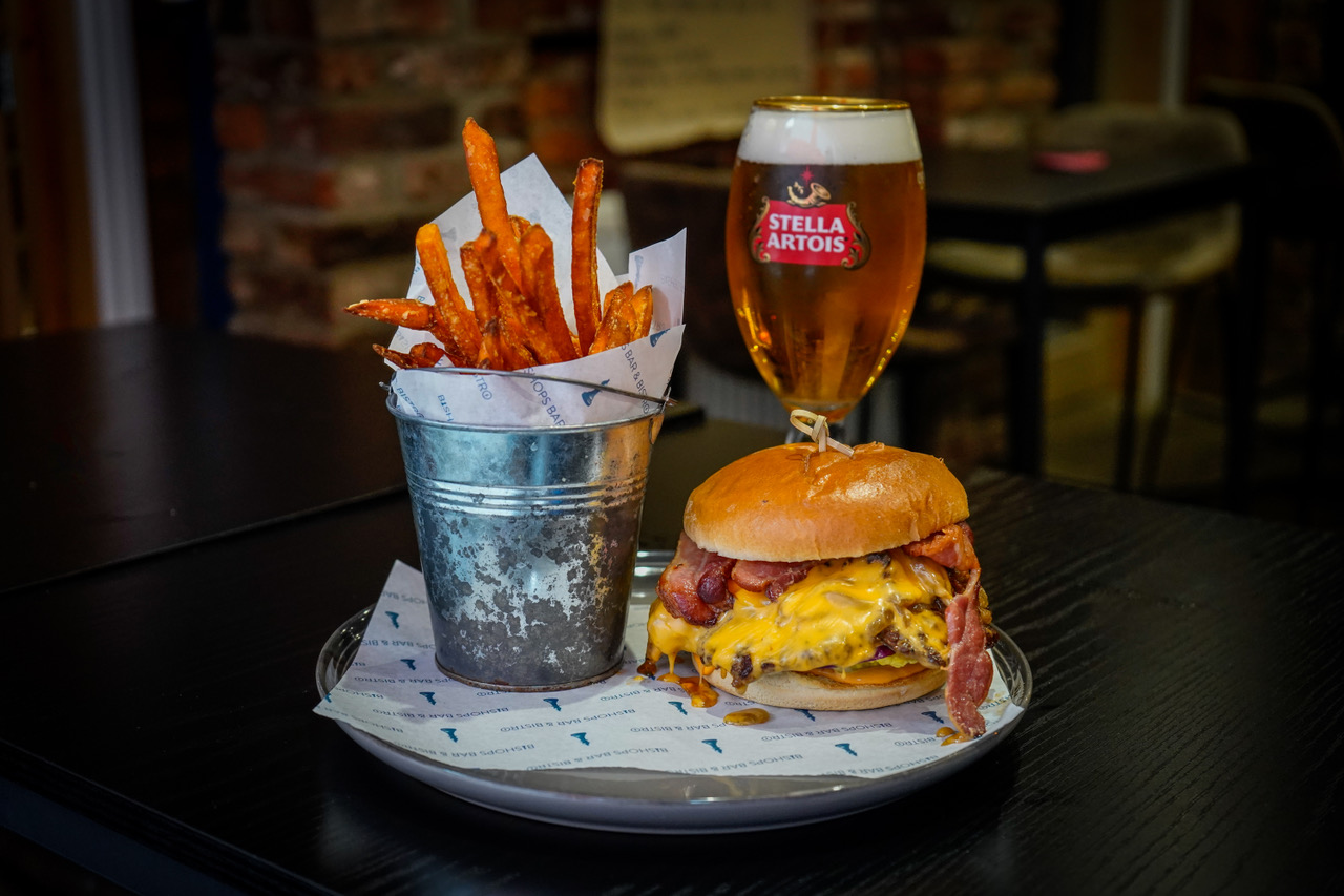 Bacon cheeseburger with sweet potato fries and a pint