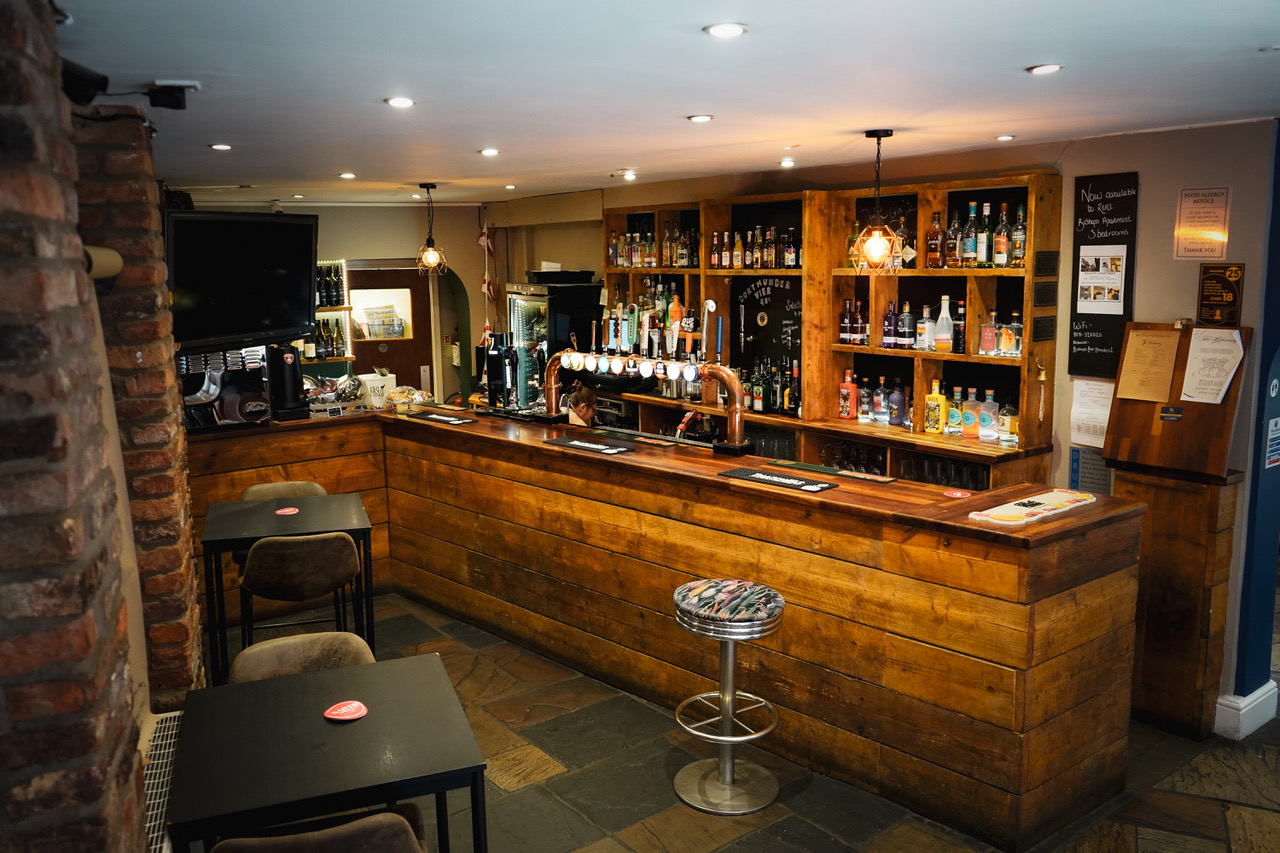 The reclaimed timber bar and stone floors