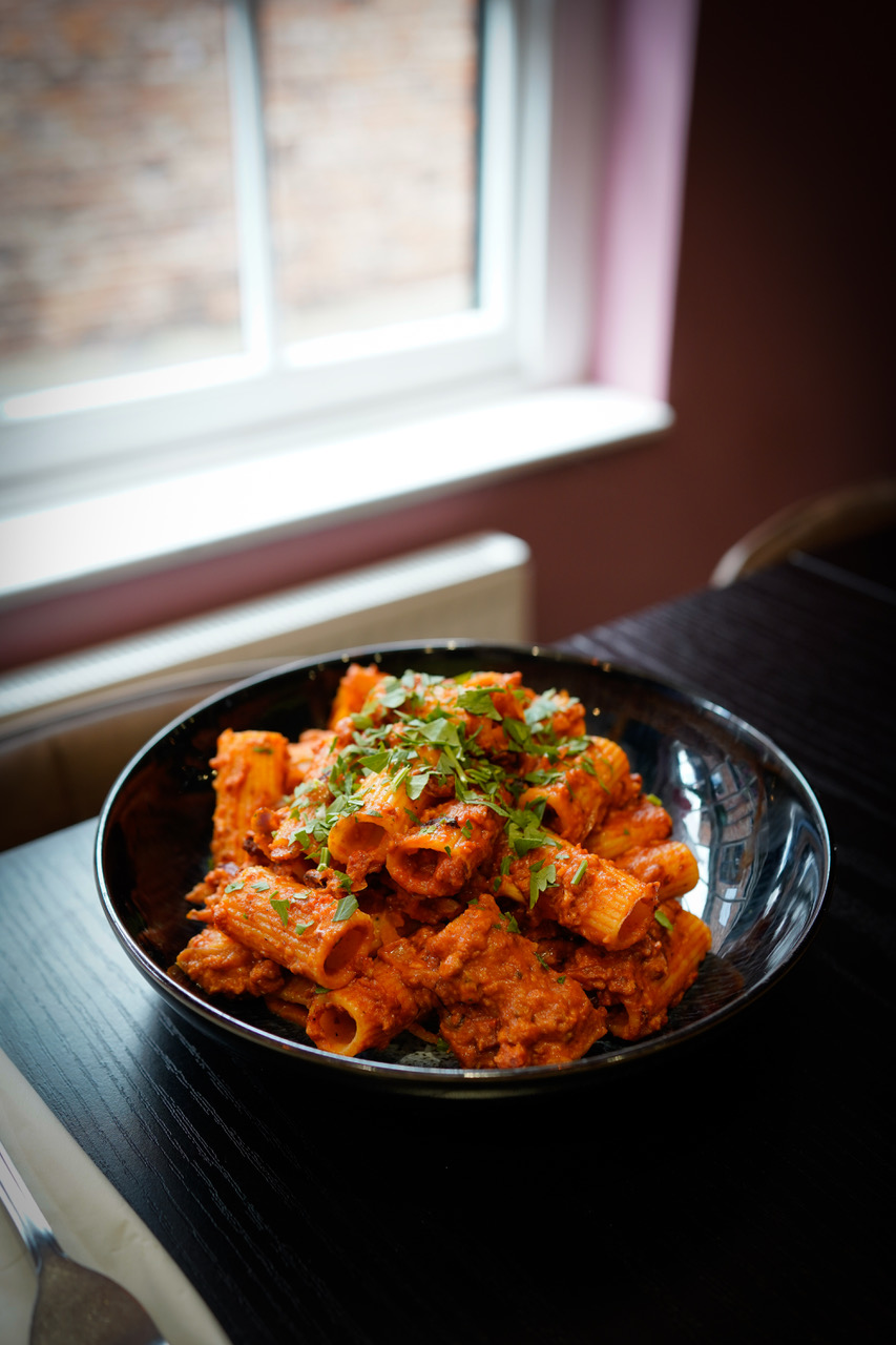 Rigatoni in a rich ragu with fresh herbs