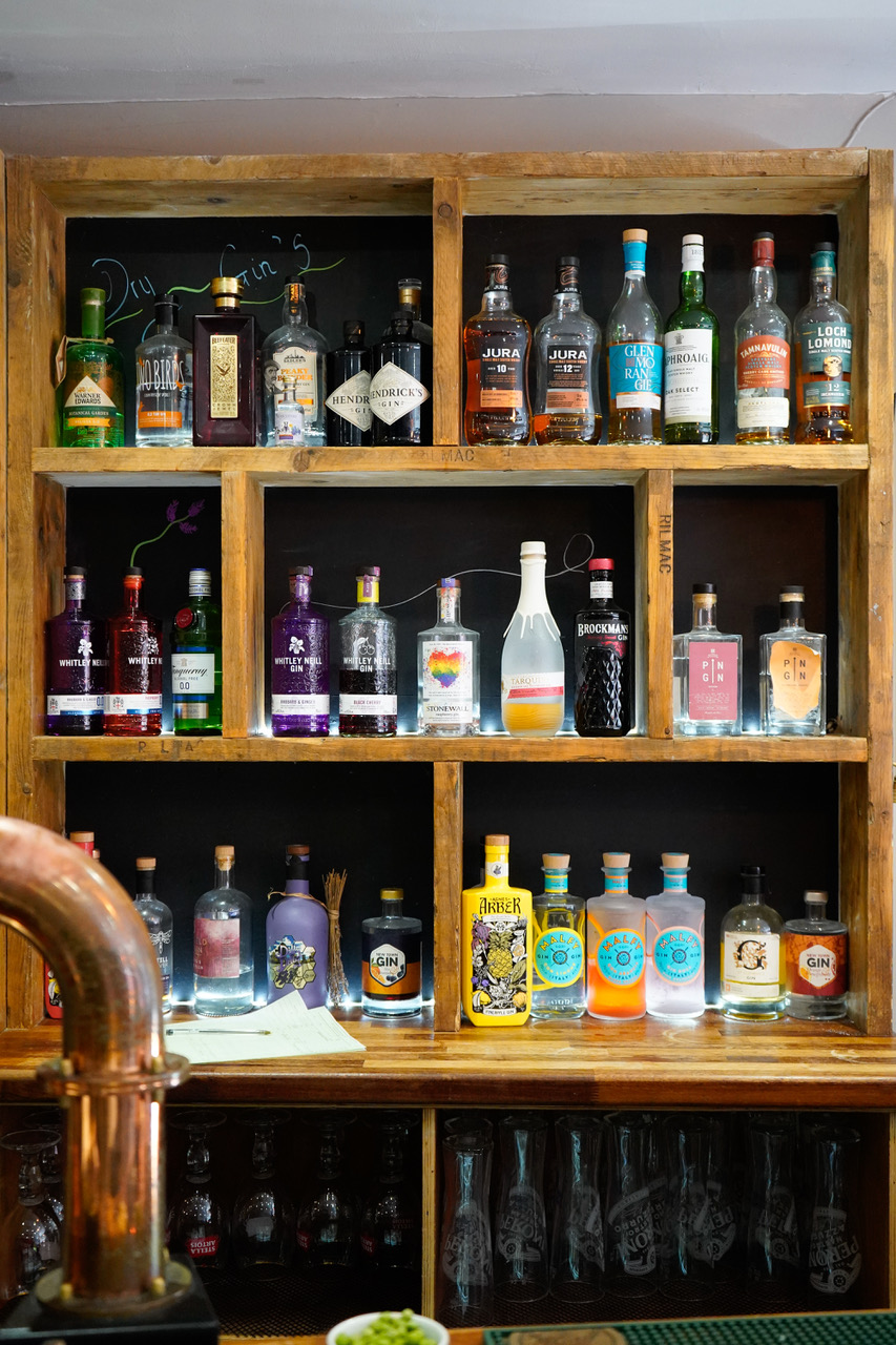 Gin and whisky shelves behind the bar