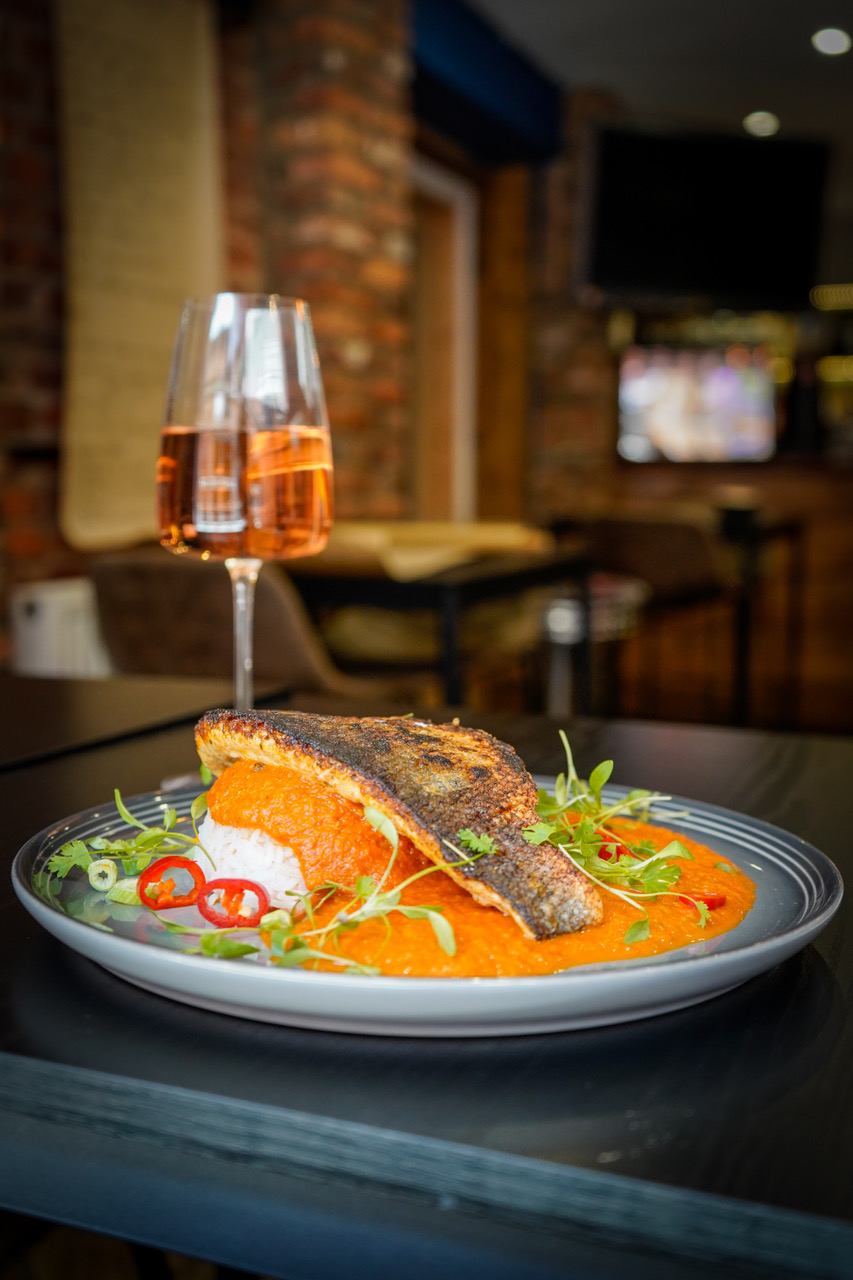Pan fried sea bass with rice and red pepper sauce