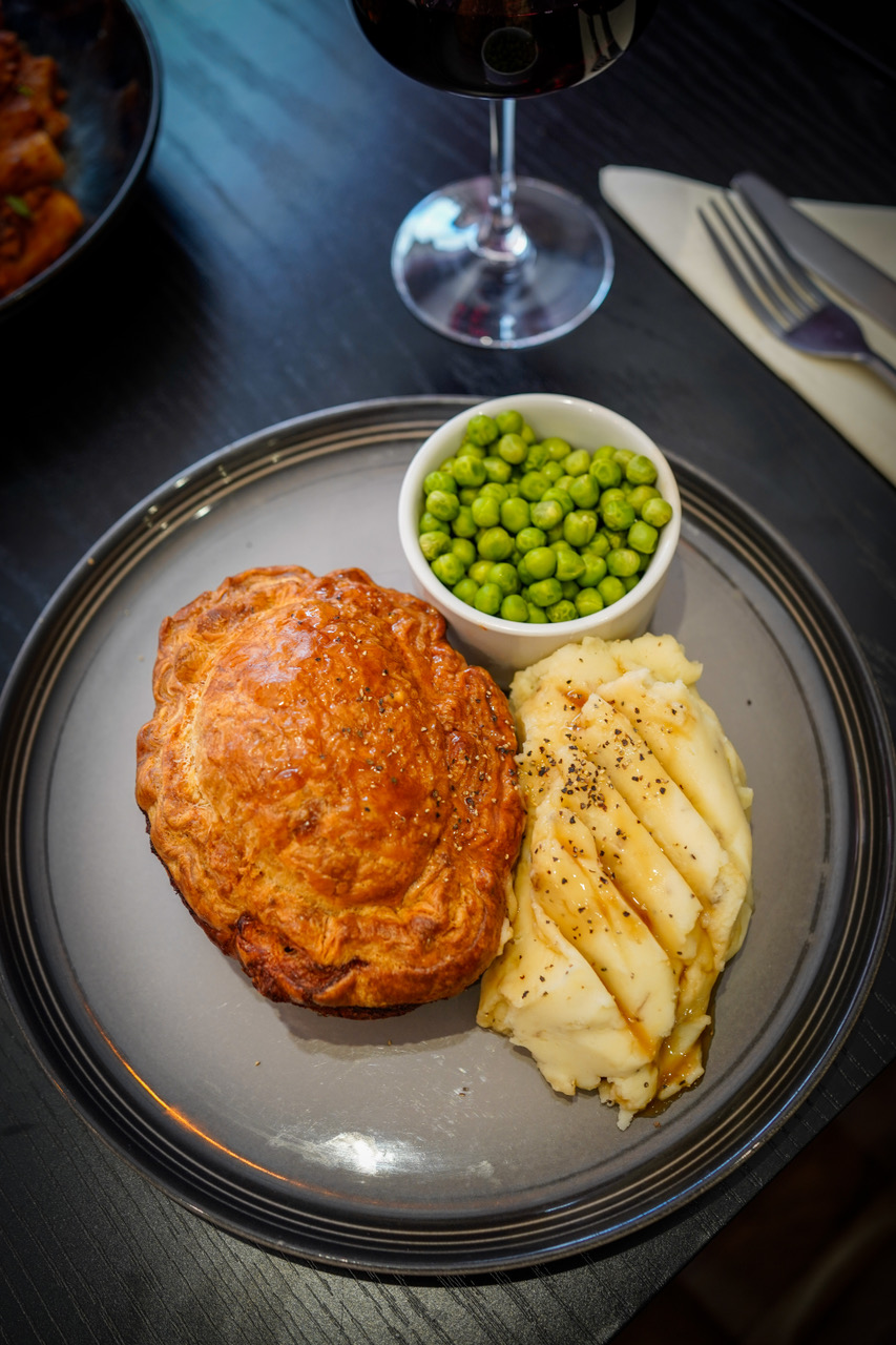 Homemade pie with mash, gravy and peas