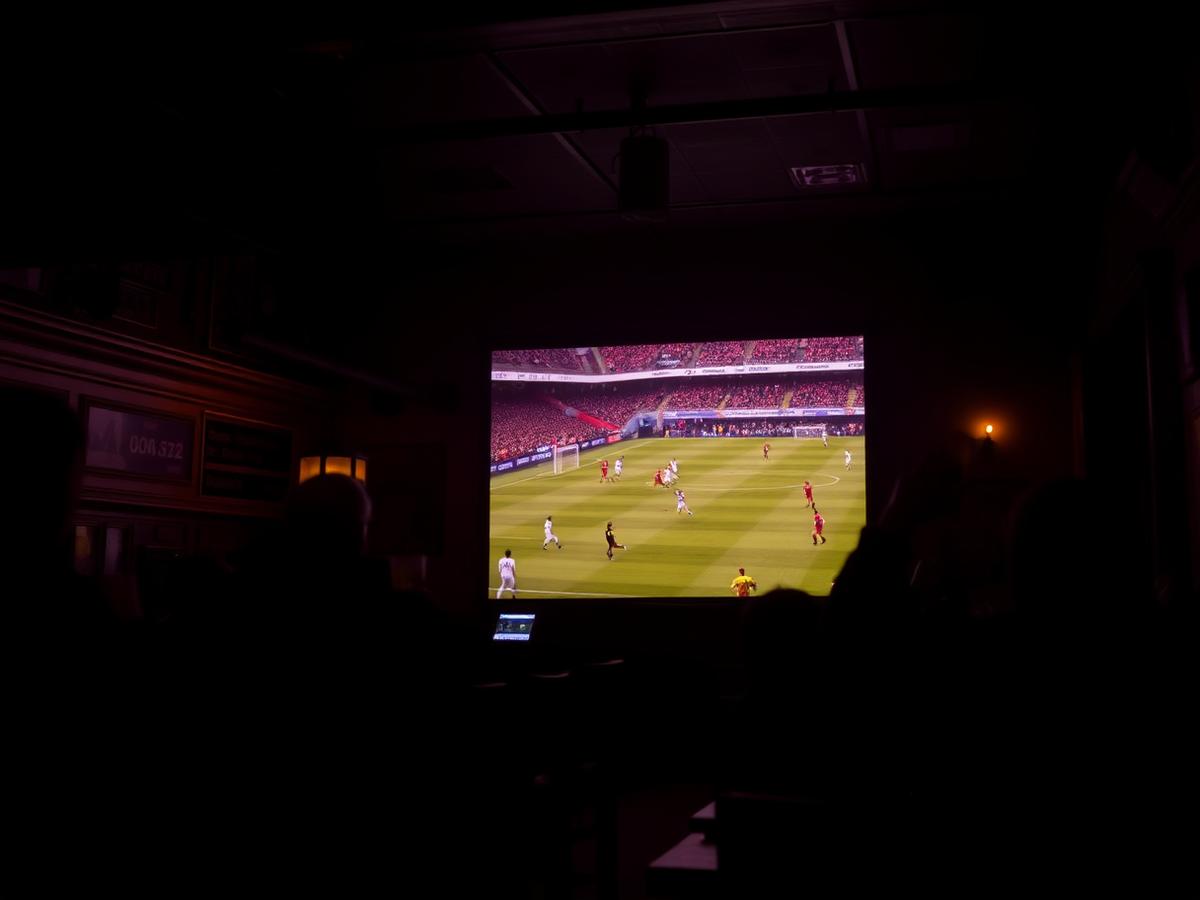 Football match on a big screen in the bar